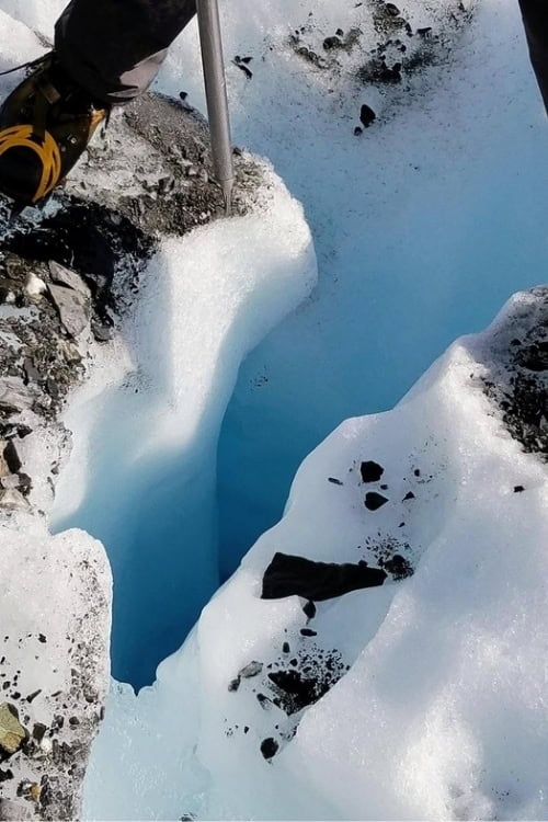 Scott straddles a deep crevasse at Matanuska Glacier. Photo by Dorothy Maillet