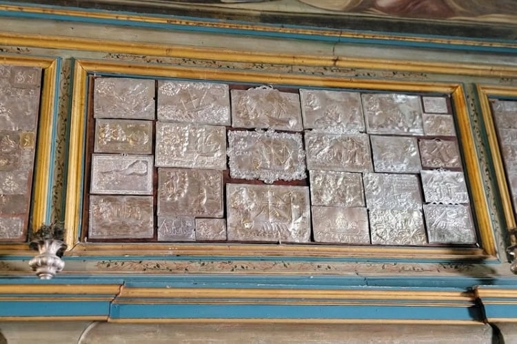 Tributes of silver depicting maritime scenes left by sailors in Our Lady of the Rocks. Photo by Eric D. Goodman