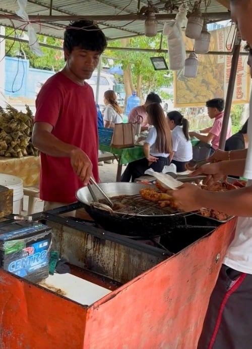 Street food preparation at an outdoor market in Mactan Island, Cebu. Photo by Nikola Mikovic