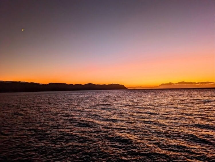 The sun sets over Souda Bay, Crete. Photo by Kathy Hosek