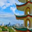View over residential buildings on Mactan Island, with the sea and mountains in the distance. Photo by Nikola Mikovic Pinterest