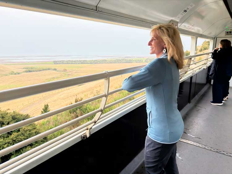 Train travel in New Zealand. Open-air viewing car aboard Great Journeys New Zealand. Photo by Benjamin Rader