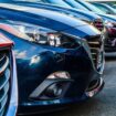 A row of parked vehicles. Photo by Obi, Unsplash