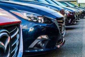 A row of parked vehicles. Photo by Obi, Unsplash