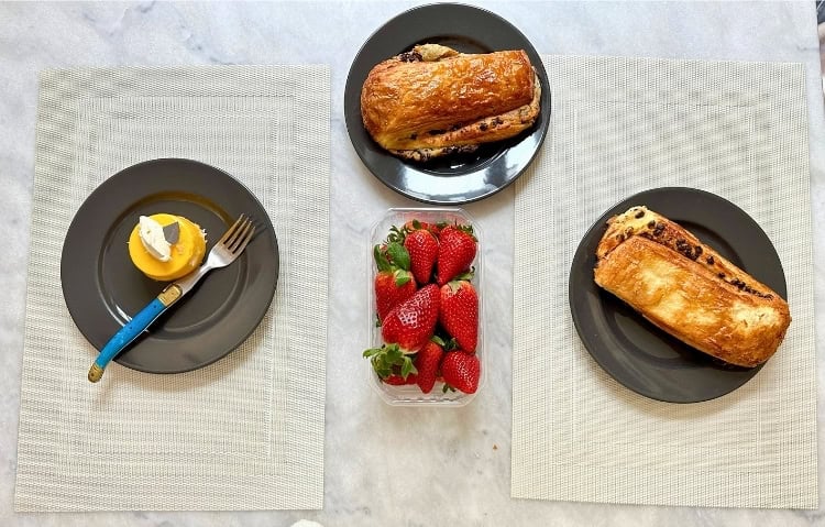 An afternoon indulgence: a passionfruit torte, pain suisse au chocolat and fresh strawberries. Photo by Isabella Miller