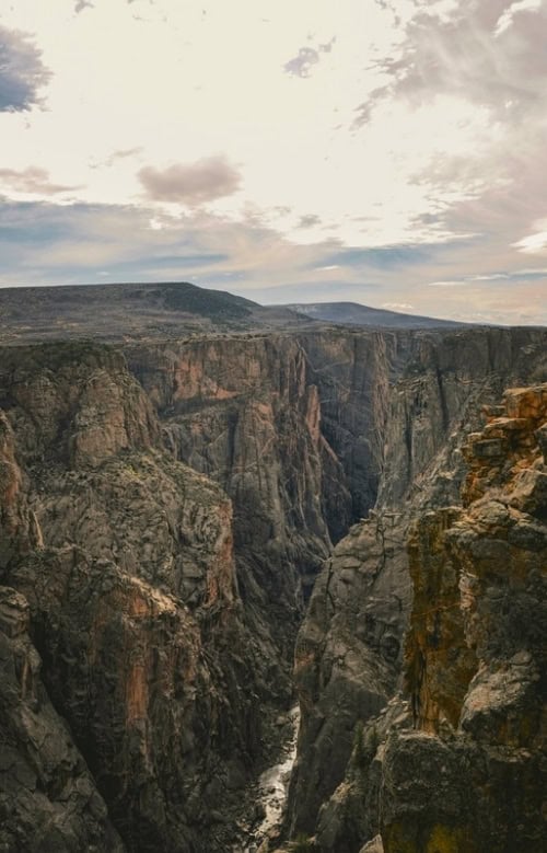 The narrow cavernous walls were cut over centuries by the Gunnison River in Black Canyon National Park, CO. Photo by Jeff Heaton, Unsplash