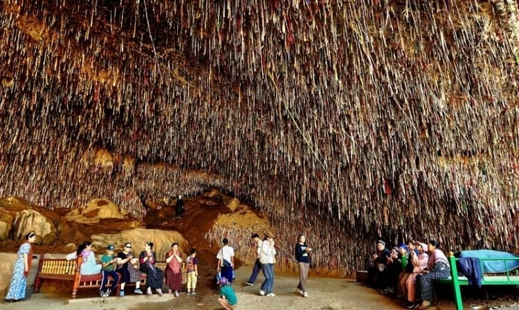 Strips of cloth representing wishes cover the ceiling of the Cave of the 40 Women. Photo by Edward Placidi