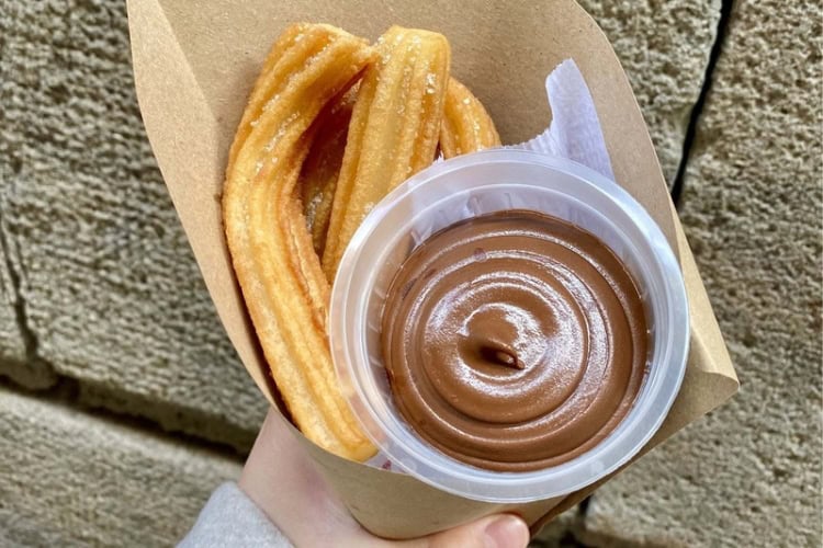 Golden churros served with rich hot chocolate. Photo by Huyen Tran