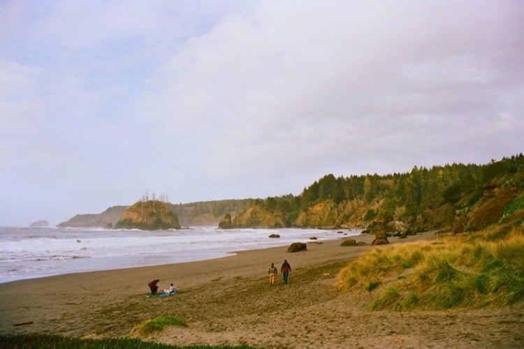 Group of people on a sandy beach in Trinidad, CA, USA. Photo by Mitchell Valine, Unsplash