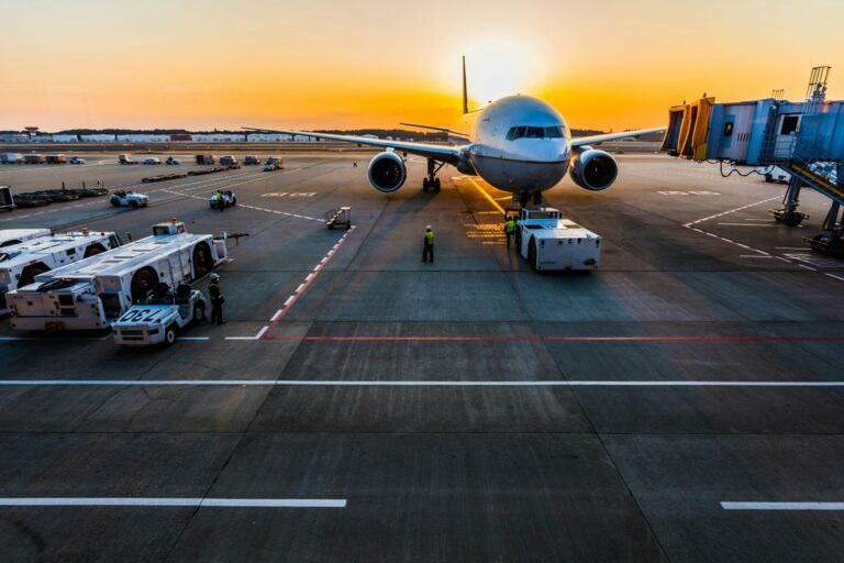 Parked airplane at sunset. Photo by Rocker Sta, Unsplash