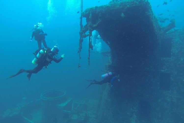 Scuba divers exploring a shipwreck. Photo courtesy of Visit Pensacola