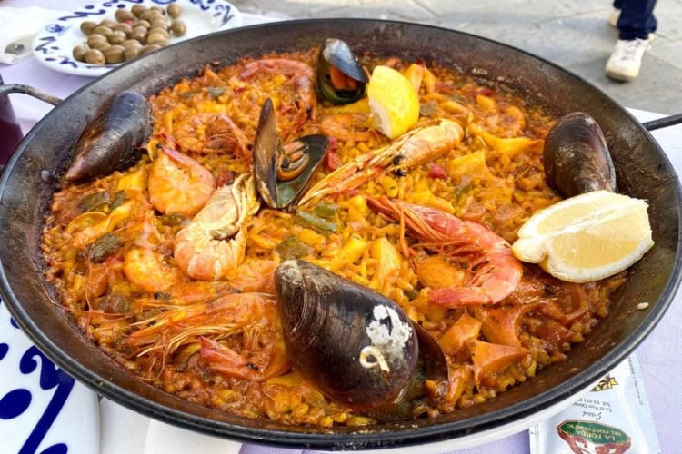 Seafood paella bursting with Mediterranean flavors. Photo by Huyen Tran