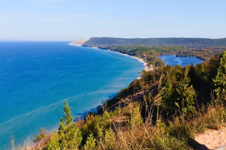 Sleeping Bear Dunes with a view of the ocean from a hill. Photo by Jeff DeWitt, Unsplash