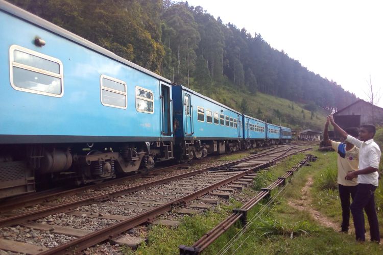 Kids stop to wave at the passing train