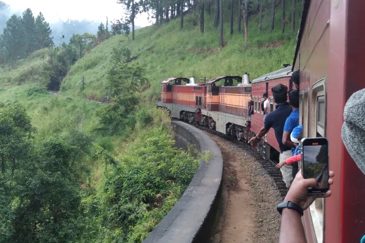 Passengers watch the hills roll past between Kandy and Ella