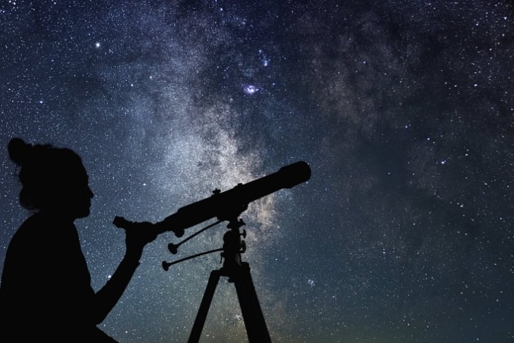 Stargazing with a telescope. Photo by Allexxandar from Getty Images via Canva