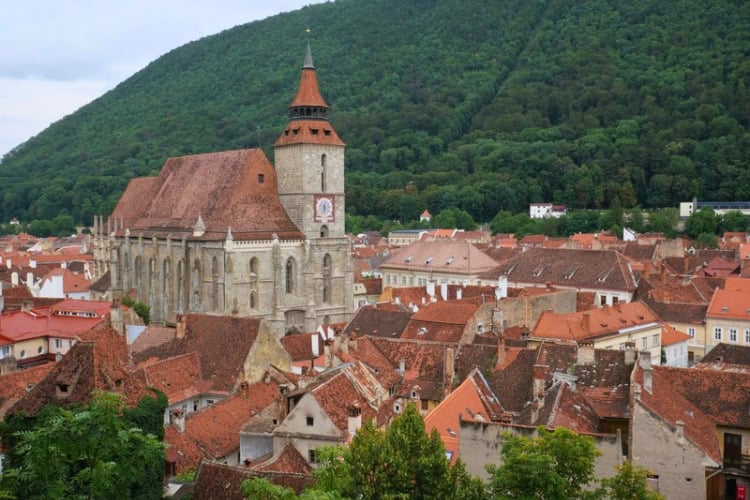The historic city of Brașov, Romania, with the iconic Black Church and the backdrop of Tampa Mountain. Photo by Andy Arbeit, Unsplash