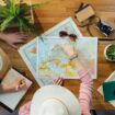 A young couple plans a vacation trip using maps. Photo by Getty Images, Unsplash
