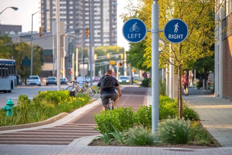 A man rides a bicycle through downtown Indianapolis. Photo courtesy of Visit Indy