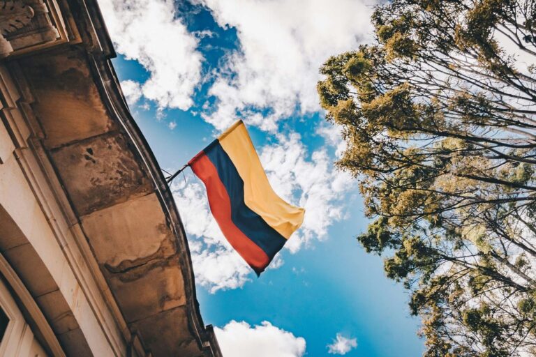 Colombian flag in Downtown Bogotá. Photo by Flavia Carpio, Unsplash