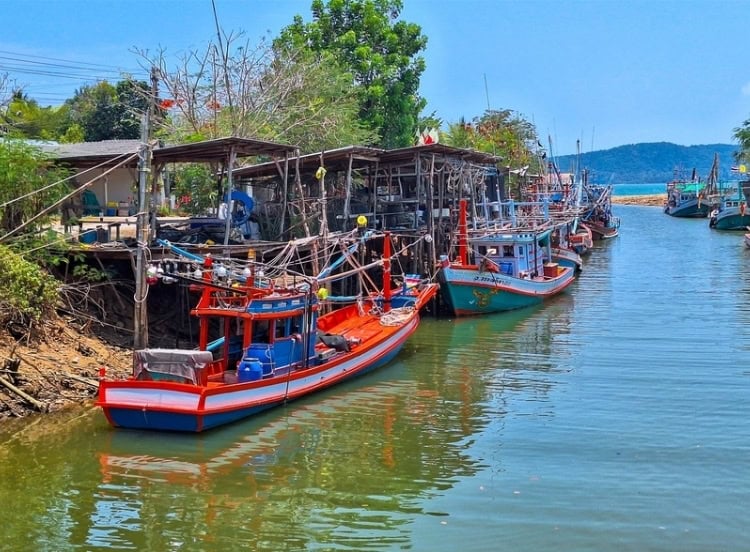 Colorful fishing boats tied up in a sheltered waterway in Thailand's Royal Coast. Photo by Michael Cullen