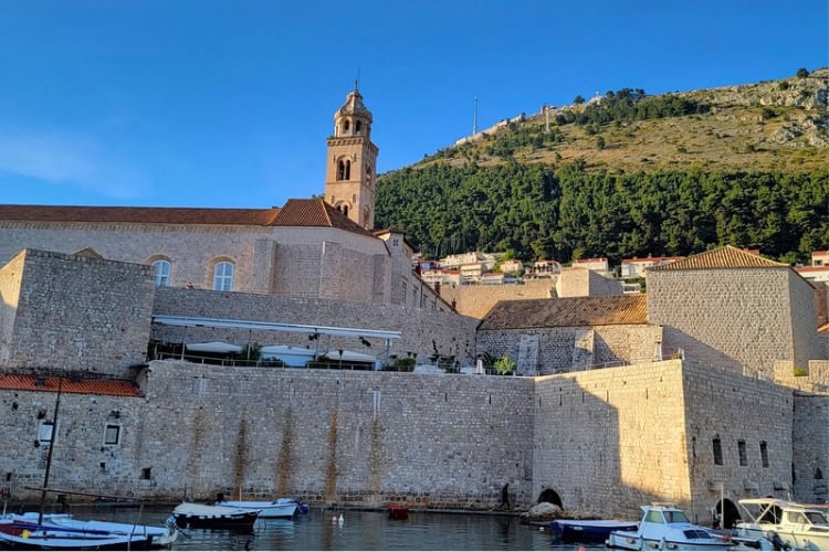Dubrovnik’s historic City Harbor, featuring the city walls and the tower of the Dominican Monastery. Photo by Eric D. Goodman
