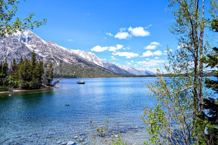 Jenny Lake and the ferry in operation throughout the summer. Photo by Frank Hosek