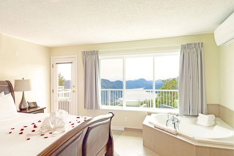 The resort features spacious guestrooms with fireplaces, plush bedding, and spa-inspired bathrooms. Photo courtesy of the property