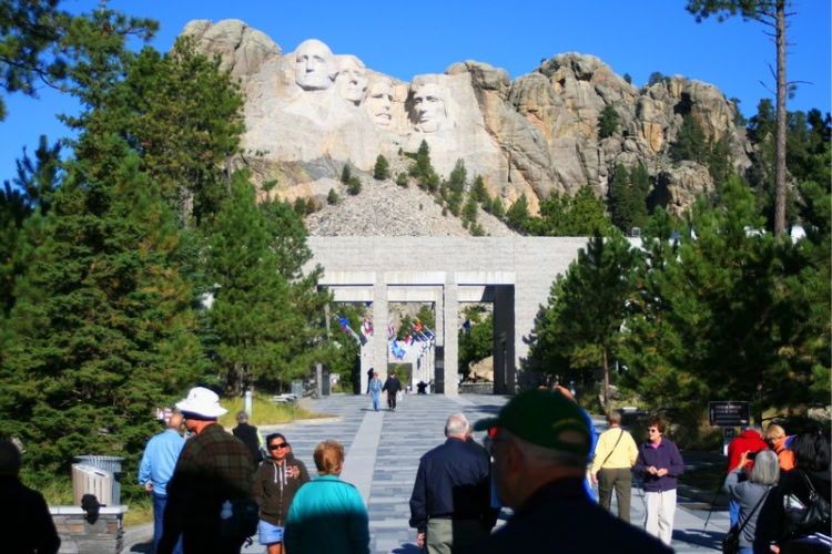 Entrance to Mount Rushmore National Memorial through the arched pavilion past the Avenue of Flags. Photo by Frank Hosek