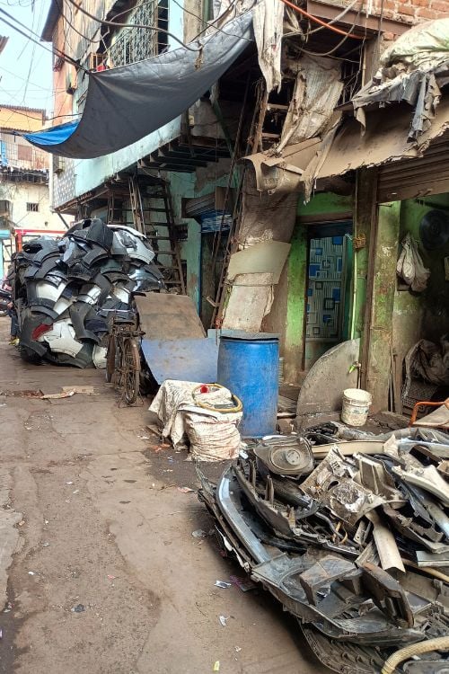 The recycle capital of India, car part remnants line the narrow alleys to be ground into usable material