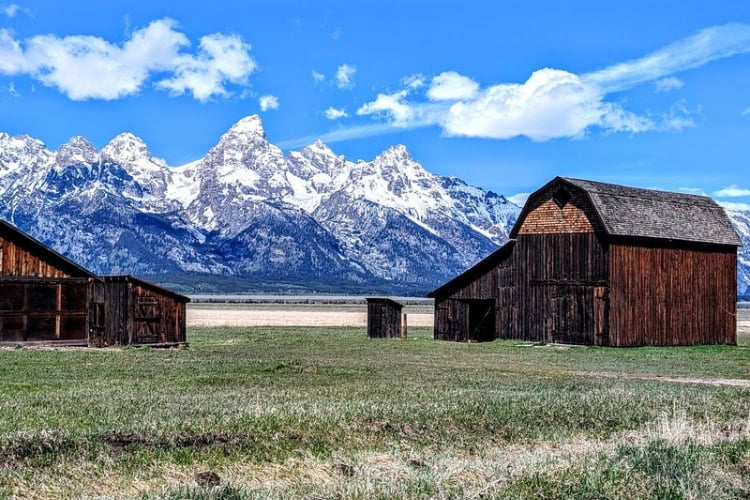 The Grand Tetons framed by a barn originally built by Thomas Murphy and later purchased by Joe Heninger on Mormon Row. Photo by Frank Hosek