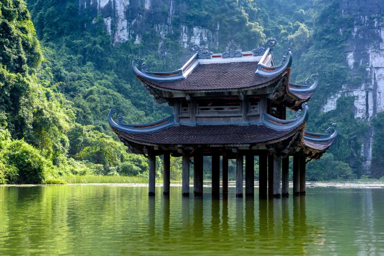 An ancient pagoda sits in the middle of the Trang An river