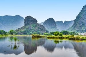 The often overlooked Ninh Binh holds a serene beauty for those who stop. Image by AlexeyPelikh from Getty Images via Canva