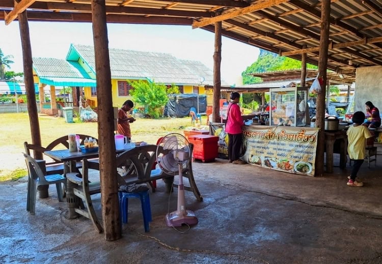 Our simple lunch stop at Ban Thun Thong, with village life unfolding around us. Photo by Michael Cullen