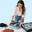Traveler organizing clothing with BAGAIL packing cubes. Photo courtesy of BAGAIL