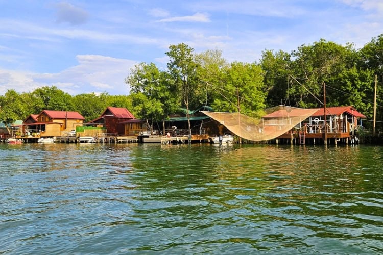 Wooden stilt houses and fishing cabins lining the riverbanks of Ada Bojana. Photo by Zuzana Zimmermannova