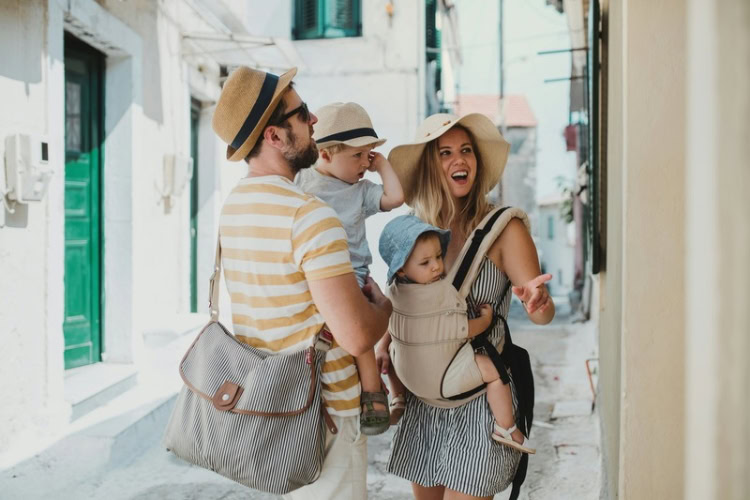 A young family with two toddler children on a summer holiday. Photo by Getty Images, Unsplash