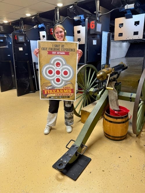 After a round with a working Gatling gun and a classic 1873 revolver, the author shows off her target at Cody Firearms Experience. Photo courtesy of Cody Firearms Experience