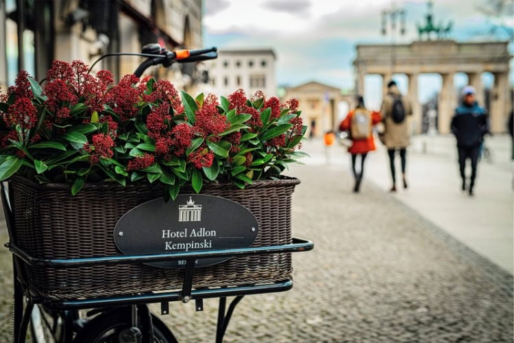 Historic Hotel Adlon sits beside Brandenburg Tor, Berlin. Photo by Adobe Stock