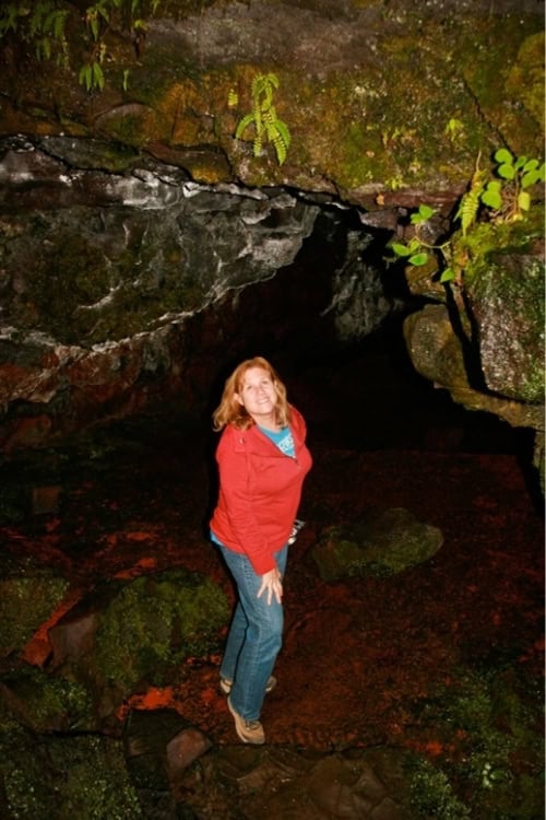 Above the entrance of Kaumana Cave, focusing on the two black openings below. Photo by Brent Cassie