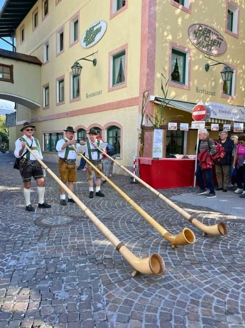 Local Austrian musicians preparing to play their Alpine horns. Photo by Dara Wissinger Putz
