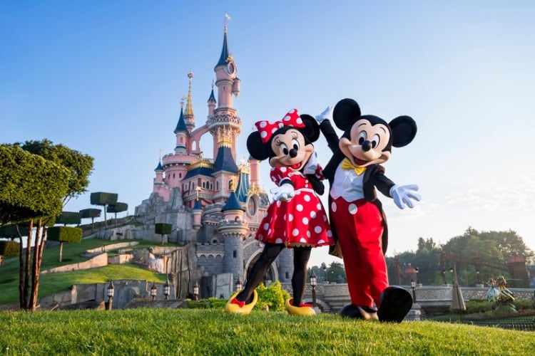 Mickey and Minnie Mouse and Sleeping Beauty Castle at Disneyland Paris. Photo by Disney