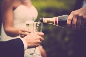 Newly-weds drinking champagne. Photo by Rene Terp, Pexels