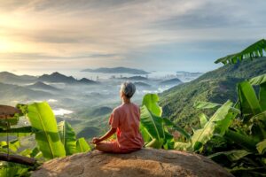 Woman looking at beautiful landscape and doing yoga. Photo by Quang Nguyen Vinh, Pexels