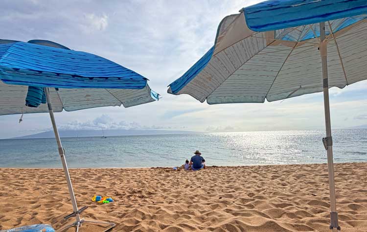 Man and little girl on beach in Maui