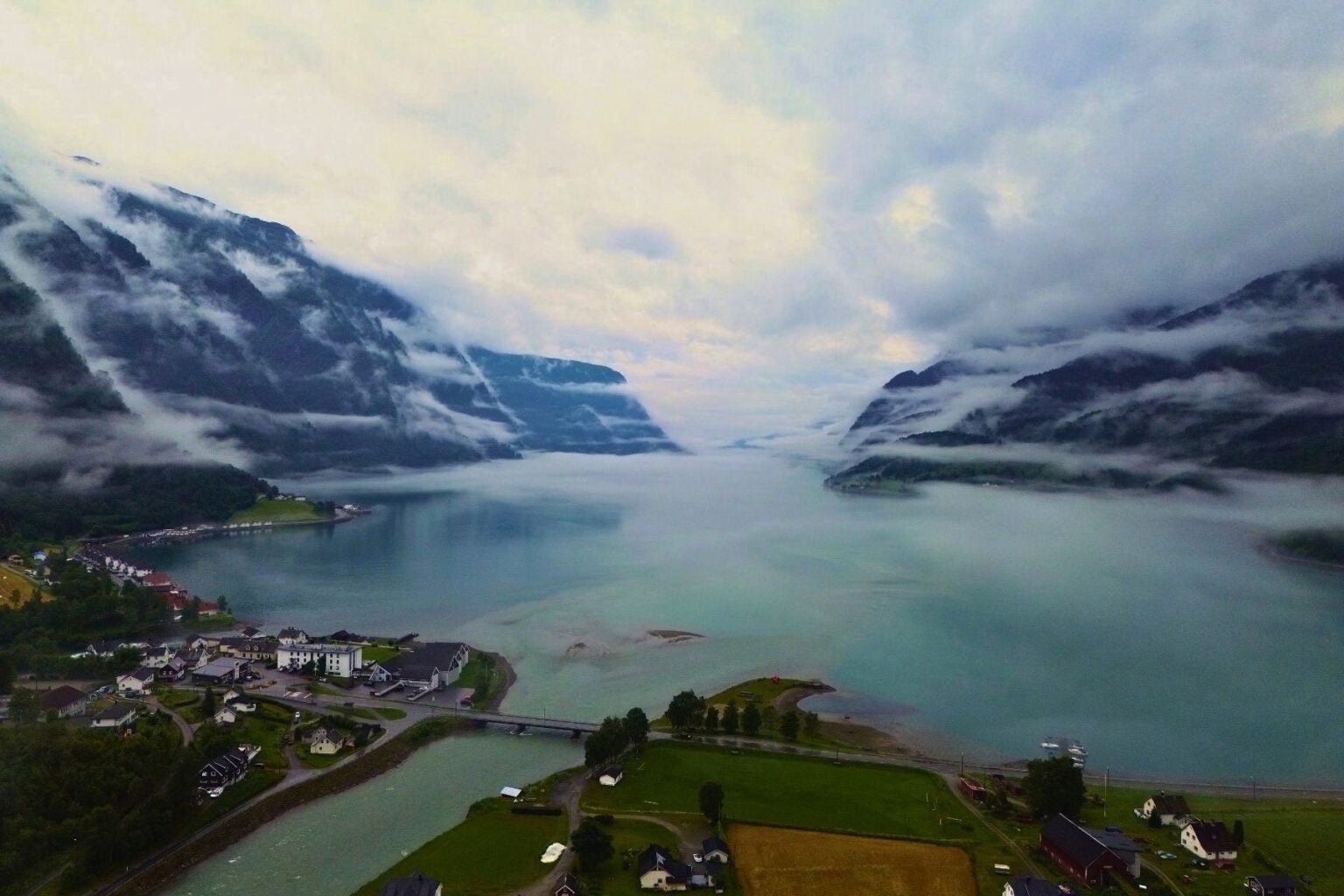 A Norway morning, lake surrounded by mountains. Photo by Nick Morrall
