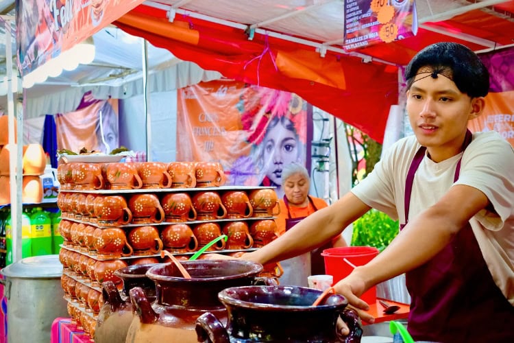 A vendor serves traditional Mexican beverages at a market stall. Photo by Gregory Rodriguez via Canva