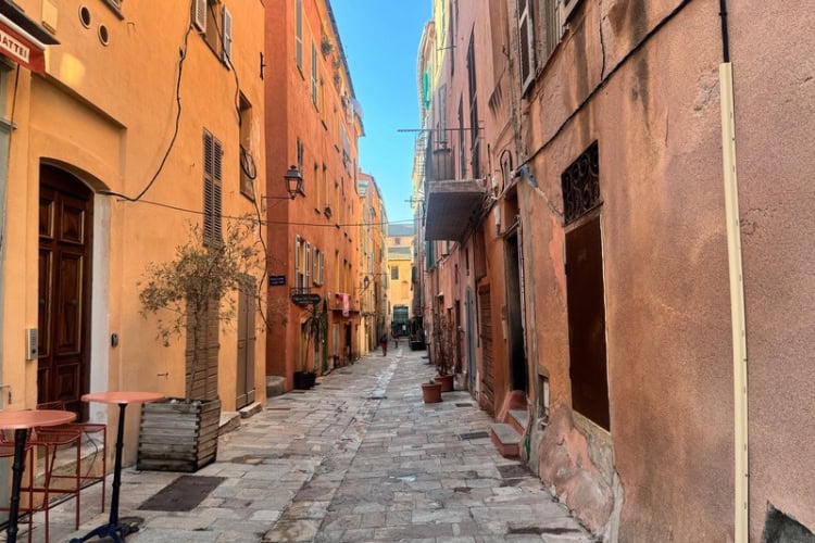 Bastia's Old Port is dominated by warm pastel colors like terracotta, soft peach, and pale yellow. Photo by Diana Ballon