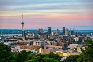 Captivating view of Auckland's skyline at dusk featuring the iconic Sky Tower under a colorful sky. Photo by Donovan Kelly, Pexels