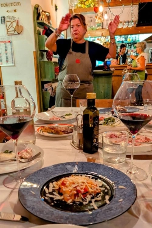 Restaurant scene in Friuli, Italy, where local food and wine are sampled. The red wine from the rare Schioppettino grape was a standout. Photo by Craig Stoltz